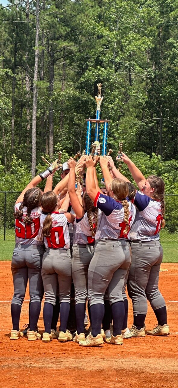 Members of the West Chatham 15U All-Star softball team celebrate after winning the 2023 N.C. Dixie Youth Softball tournament in Southport on July 12.